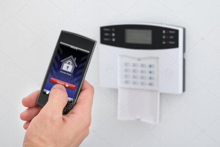 Modern intruder alarm keypad mounted on a wall