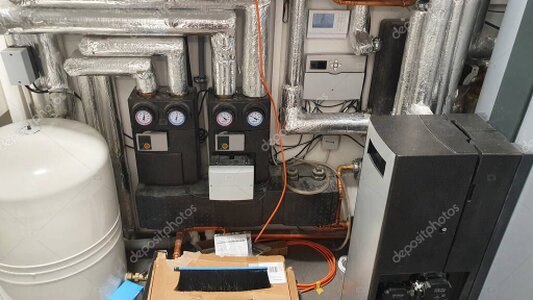 Person adjusting smart thermostat in modern home